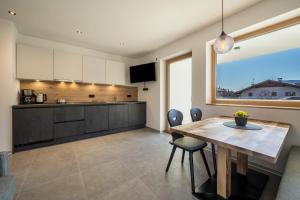 a kitchen and dining room with a table and chairs at sunnig Apartment Sonnenlicht in Vollan