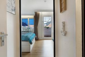 a bedroom with a bed and a mirror at Ostseeperle mit Schwimmbad in Dahme +15 photos