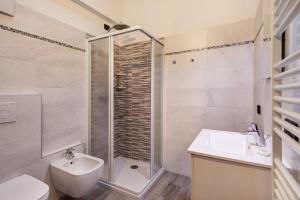 a bathroom with a shower and a sink and a toilet at Casa Nicoletta inverno in Livigno