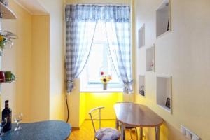 a dining room with a table and a window at Михайловская in Kyiv