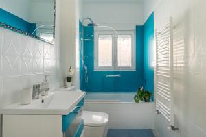 a blue and white bathroom with a toilet and a sink at Little Alhambra in Dúrcal +29 photos
