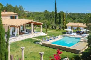 a house with a swimming pool in a yard at Villa Golf Marina Premium in Pollença