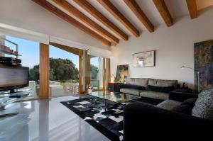 a living room with a couch and a glass table at Villa Golf Marina Premium in Pollença