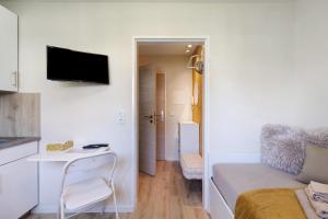 a small room with a bed and a small table at Mini Apartment in Bayreuth