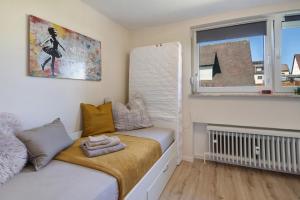 a small room with a bed and a window at Mini Apartment in Bayreuth