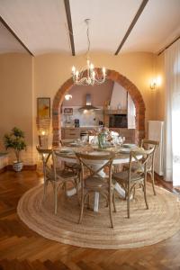 a dining room with a table and chairs at Tuscan Retreat Private Spa Villa in Lucignano