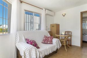 a living room with a couch and a table at Complejo Alejandra in Conil de la Frontera +73 photos