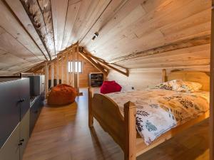 a bed in a room with a wooden ceiling at Gite Le Mazot in Albiez-Montrond