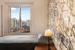 a bedroom with a bed and a window at Seaside Escape in Funchal