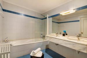 a bathroom with a tub and two sinks and a bath tub at Seaside Escape in Funchal +12 photos