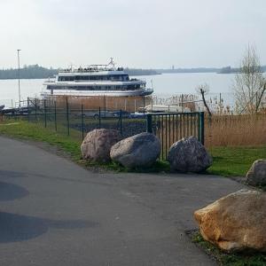 a cruise ship in the water with some rocks at Ferienwohnung Annett in Böhlen