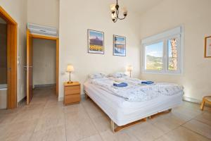 a bedroom with a large bed and a window at Villa Fuentes in Almuñécar +21 photos