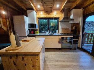 a kitchen with a wooden counter top in a room at Le Chalet Aura et Jacuzzi in Abreschviller +27 photos