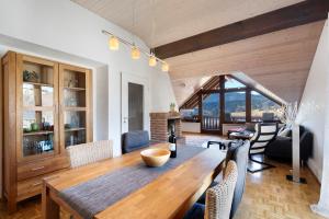 a dining room with a wooden table and chairs at Ferienwohnung Panoramablick in Lenzkirch