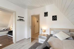 a bedroom with a bed and a room with a door at Fewo Zeitzauber in Marsberg