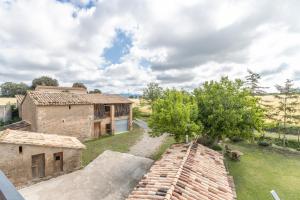an aerial view of an old house and a tree at Casa ponet in Solsona
