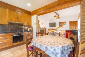 a kitchen and dining room with a table and chairs at Casa ponet in Solsona