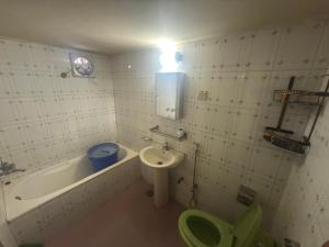 a bathroom with a toilet and a sink and a tub at Garden tower,sylhet in Sylhet