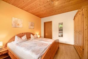 a bedroom with a large bed with a wooden headboard at Casa Mia in Bad Dürkheim