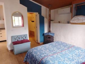 a bedroom with a bed and a fireplace in it at Nova Aurora in Lousã