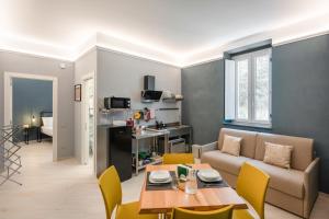 a living room with a couch and a table at Dimora Borgo Antico Lucia in Ascea
