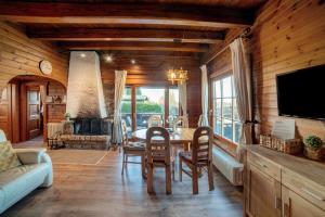 a living room with a table and a fireplace at Chalet Bühberg Alm in Bad Lauterberg