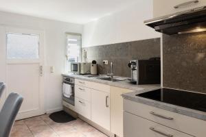 a kitchen with a sink and a stove top oven at Ferienhaus in Zernitz +15 photos