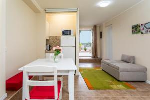 a living room with a white table and a couch at Pètra Janca in Aci SantʼAntonio +16 photos