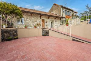 a brick patio in front of a house at Pètra Janca in Aci SantʼAntonio