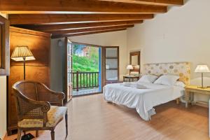 a bedroom with a bed and a balcony at La Ceriquina in Nava +20 photos