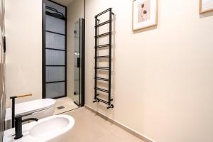 a bathroom with a toilet and a sink at Dimora Màufra in Locorotondo +11 photos