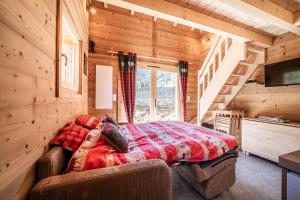 a bedroom with a bed in a log cabin at Chalet Léonie in Abondance