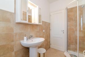 a bathroom with a sink and a shower at Casa Lucia San Teodoro 1 in Schifoni +15 photos