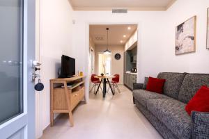 a living room with a couch and a tv at Dimora Màufra in Locorotondo