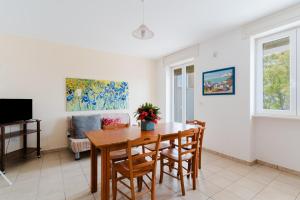 a dining room with a table and chairs at Residence Punta Pizzo in Marina di Mancaversa
