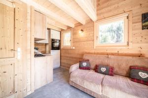 a living room with a couch in a log cabin at Chalet Léonie in Abondance +15 photos