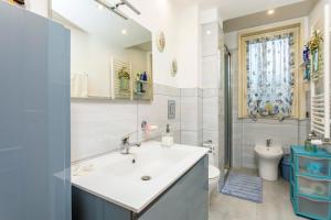 a bathroom with a sink and a toilet at Villetta Mare e Monti in Mascali