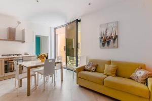 a living room with a yellow couch and a table at Casa Vacanza Susanna in Otranto