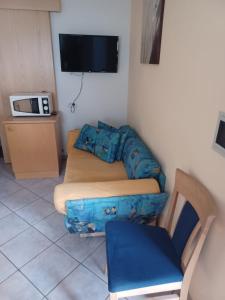 a small living room with a couch and a tv at App Sonne Nr 14 in Lutago