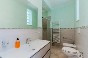 a bathroom with a toilet and a sink and a shower at Casa Vacanza Susanna in Otranto +21 photos