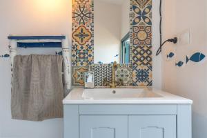 a bathroom with a white sink and a mirror at Cortijo La Alamea in Almuñécar +21 photos