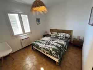 a bedroom with a bed and two windows at Maison Corsica vue mer exceptionnel in Cervione