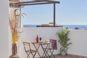 a table and chairs on a balcony with a view of the ocean at Nerja Boutique 204 Beauty in Nerja