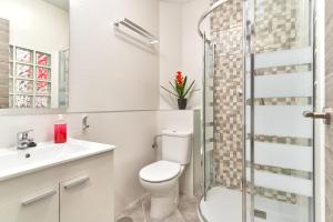 a bathroom with a toilet and a sink and a shower at Nerja Boutique 204 Beauty in Nerja +16 photos