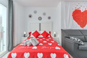 a bedroom with a red bed with hearts on it at Nerja Boutique 204 Beauty in Nerja