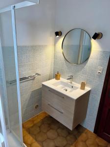 a bathroom with a sink and a mirror at Maison Corsica vue mer exceptionnel in Cervione +30 photos