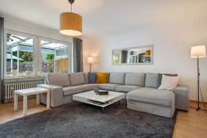 a living room with a couch and a table at Casa Noho in Nonnenhorn