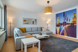 a living room with a couch and a table at Casa Noho in Nonnenhorn +19 photos