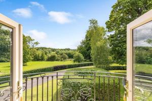 an open balcony with a view of a garden at Ballagh House in Navan