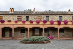 an old stone building with flower boxes on it at Apartament Monastero in Cortona